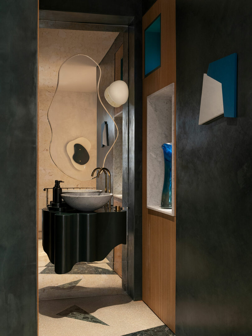 A wall mounted, mirrored lavatory.