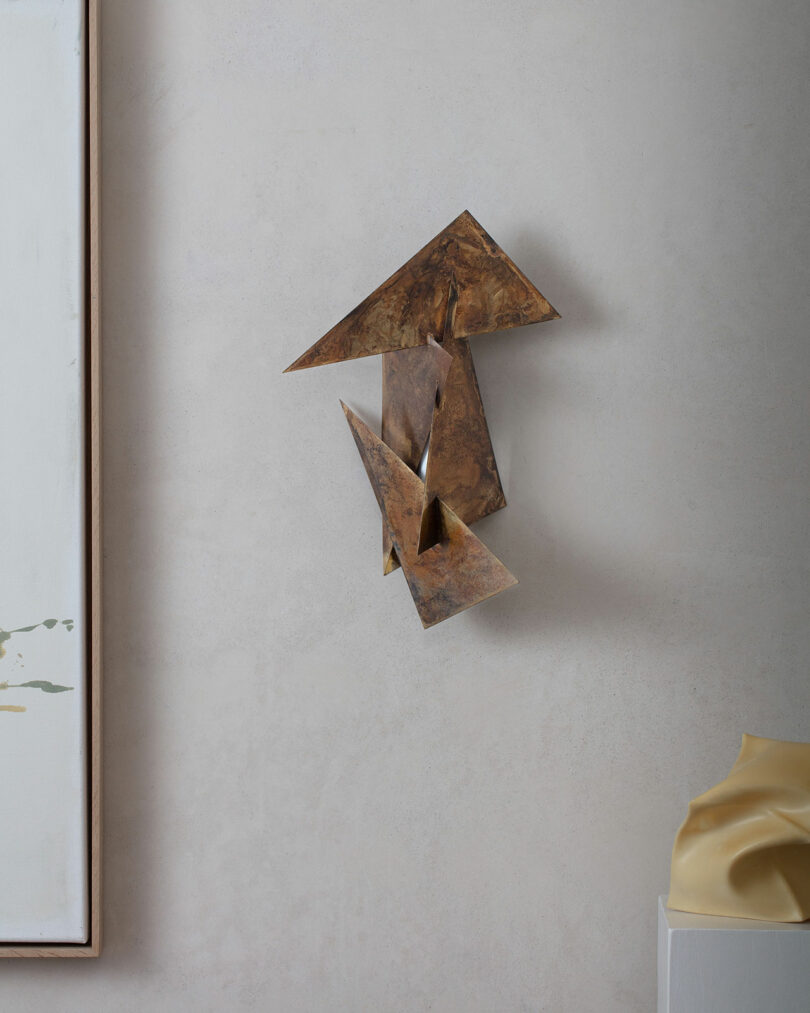 Geometric wall sconce turned off.