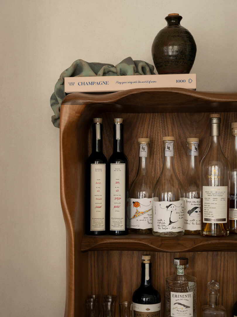 Bookcase with bottles on it.