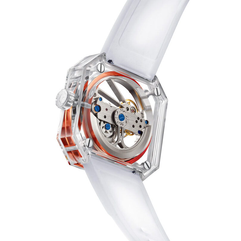Back transparent view of the Ritmo Mundo Pegasus Watch with exposed mechanical movement and orange accents.