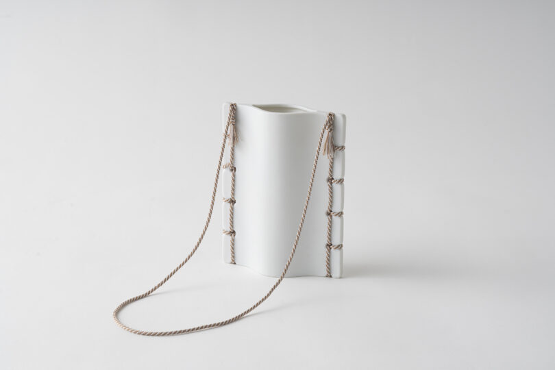 ceramic vase with thread detail on white table