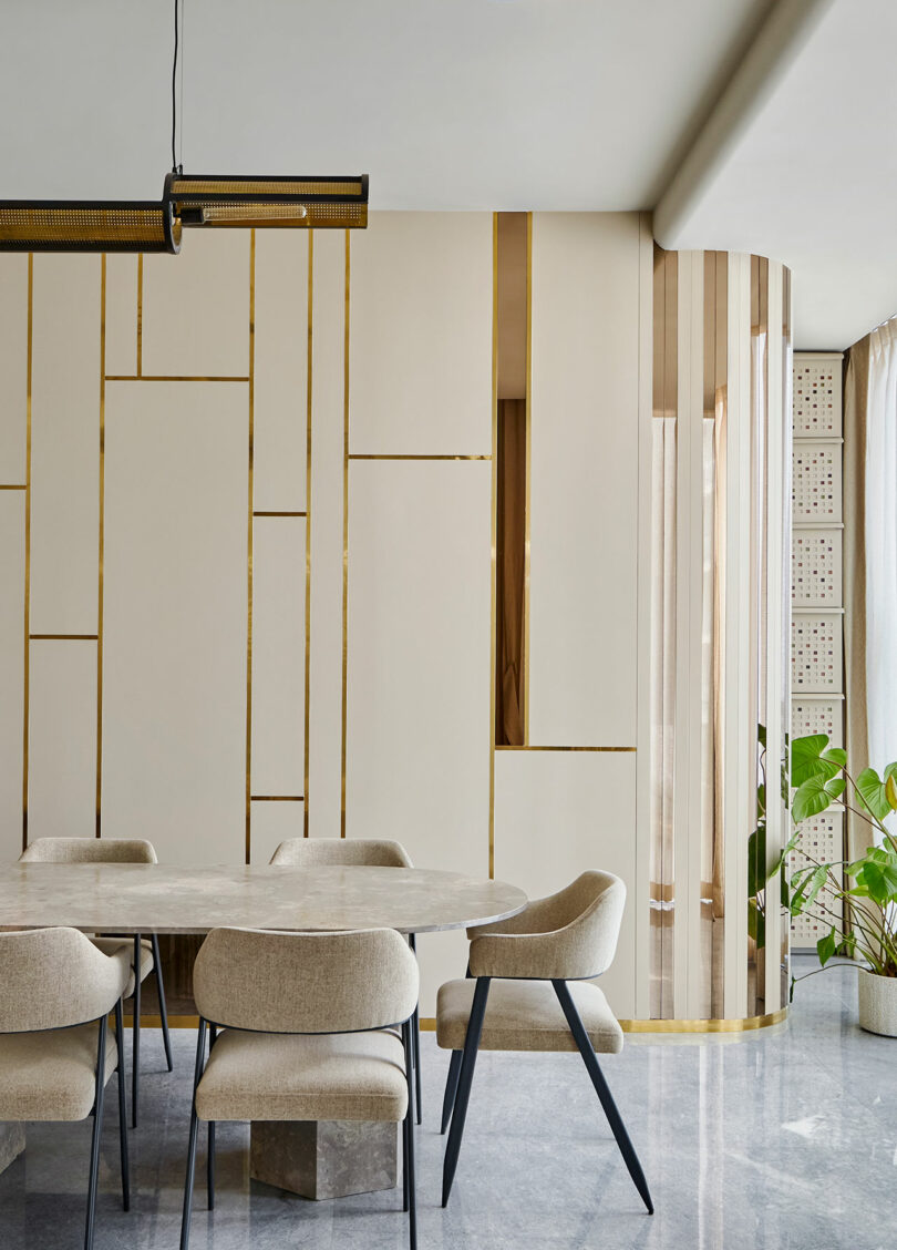Modern dining room with geometric wall paneling and minimalist furniture.