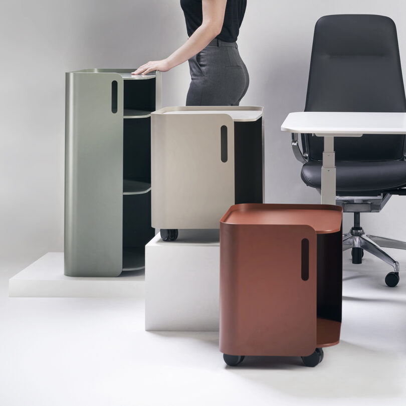 Three modern office storage solutions in different colors with a sleek design, featuring wheels for mobility.