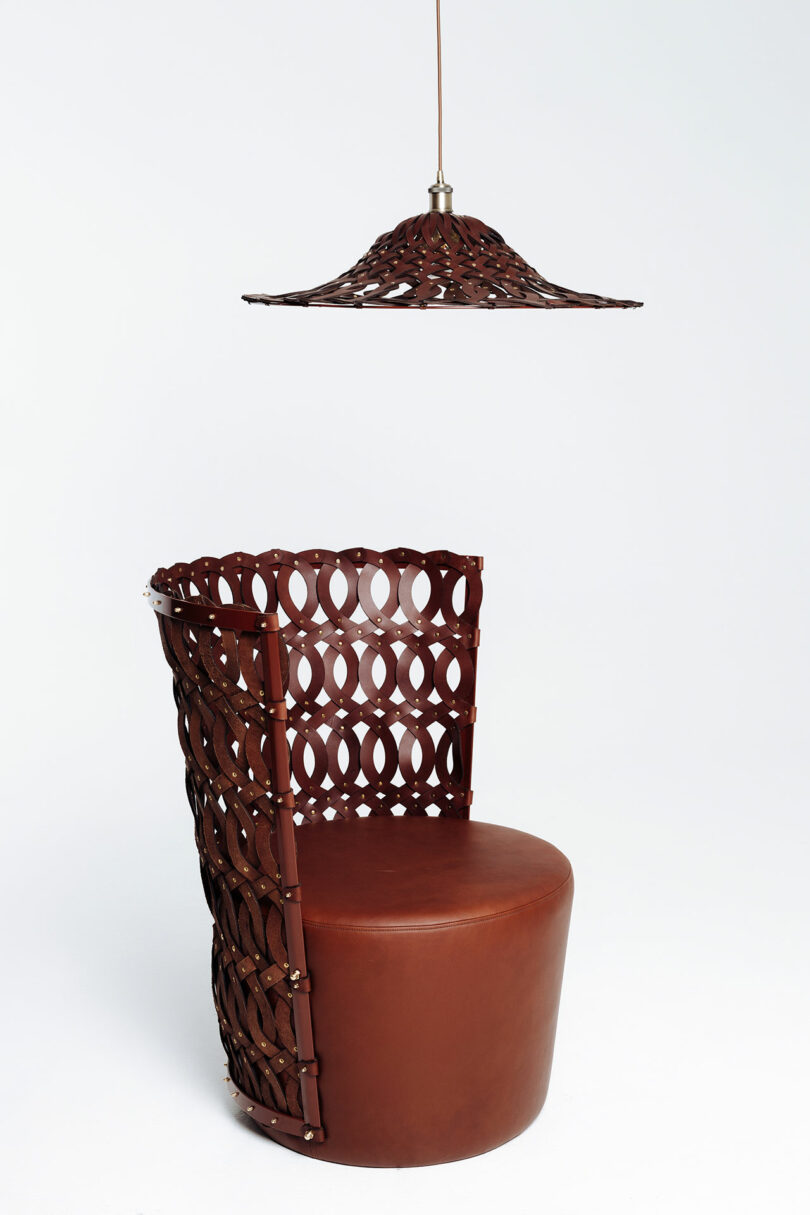 A modern chair and pendant light with matching geometric designs against a white background.