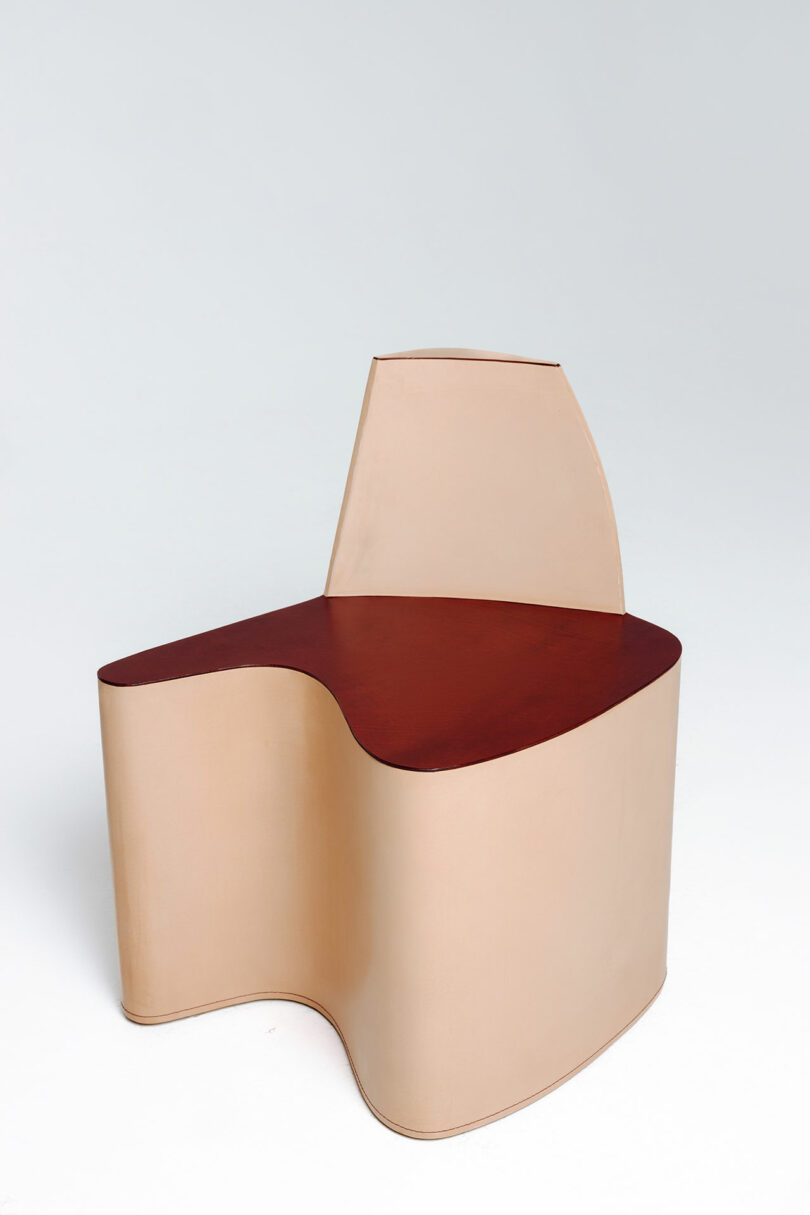 Modern chair with a curved design and two-tone color scheme.
