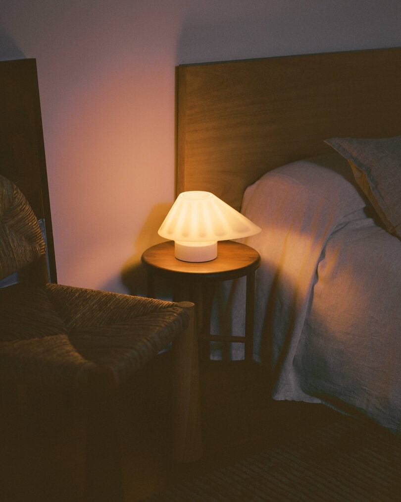 A bed with a lamp next to it.