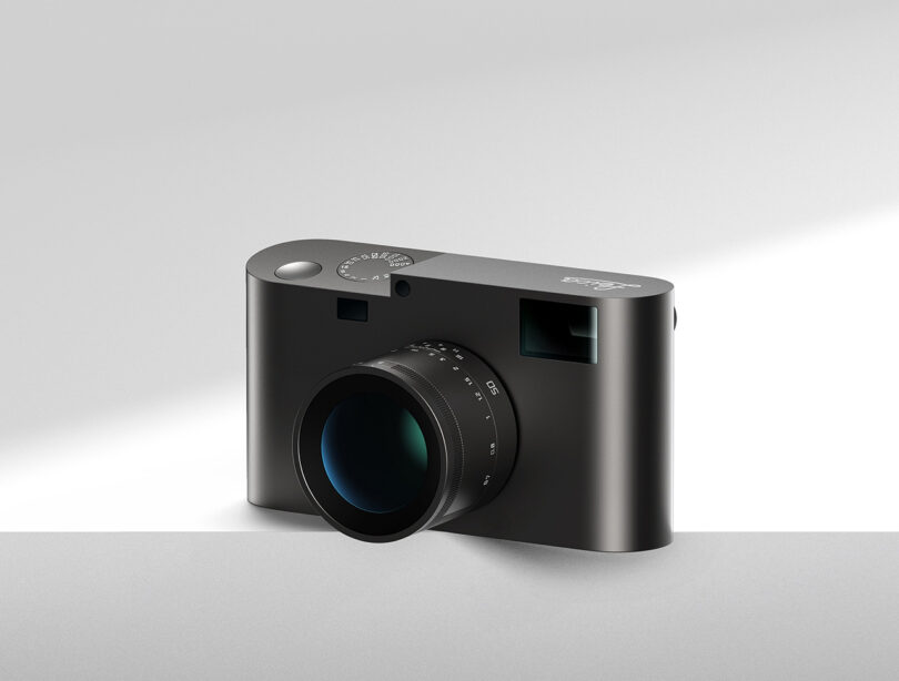 A Leica M Reimagined Concept camera is sitting on a white surface with left side hanging partially off from the edge.