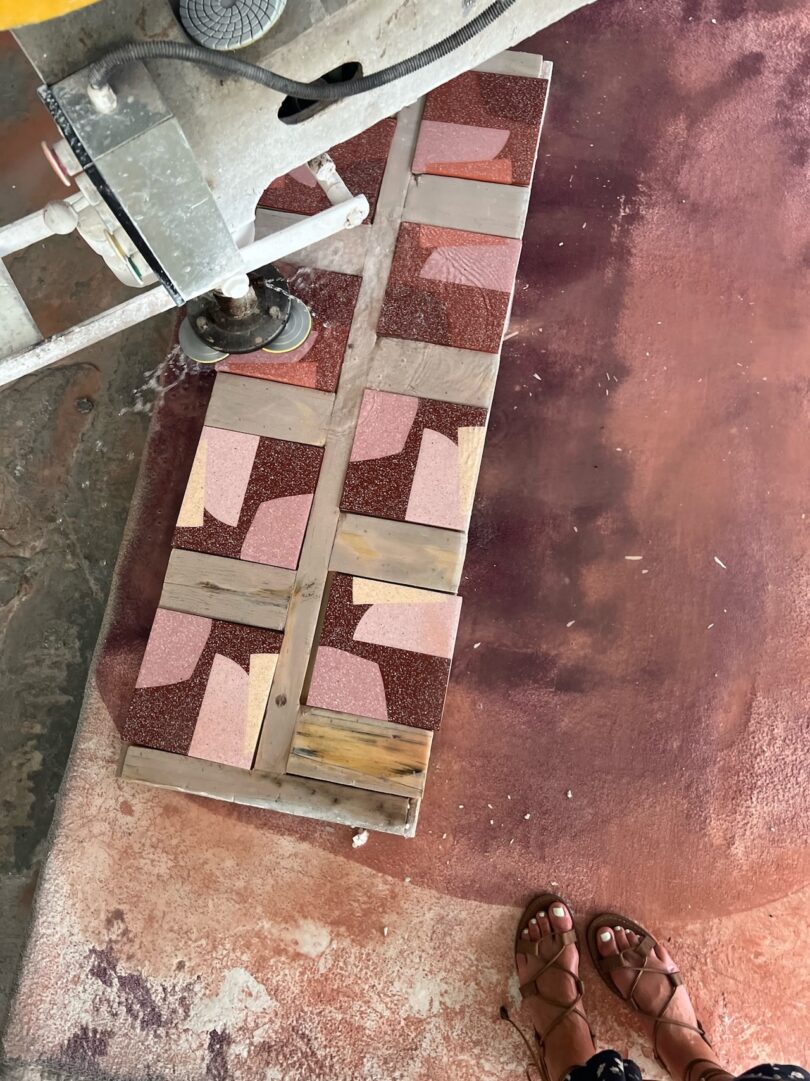burgundy and pink tiles with abstract shapes being grinded and polished