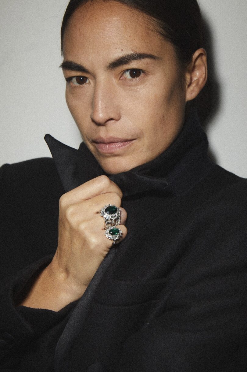 woman wearing black coat and two rings on her hand