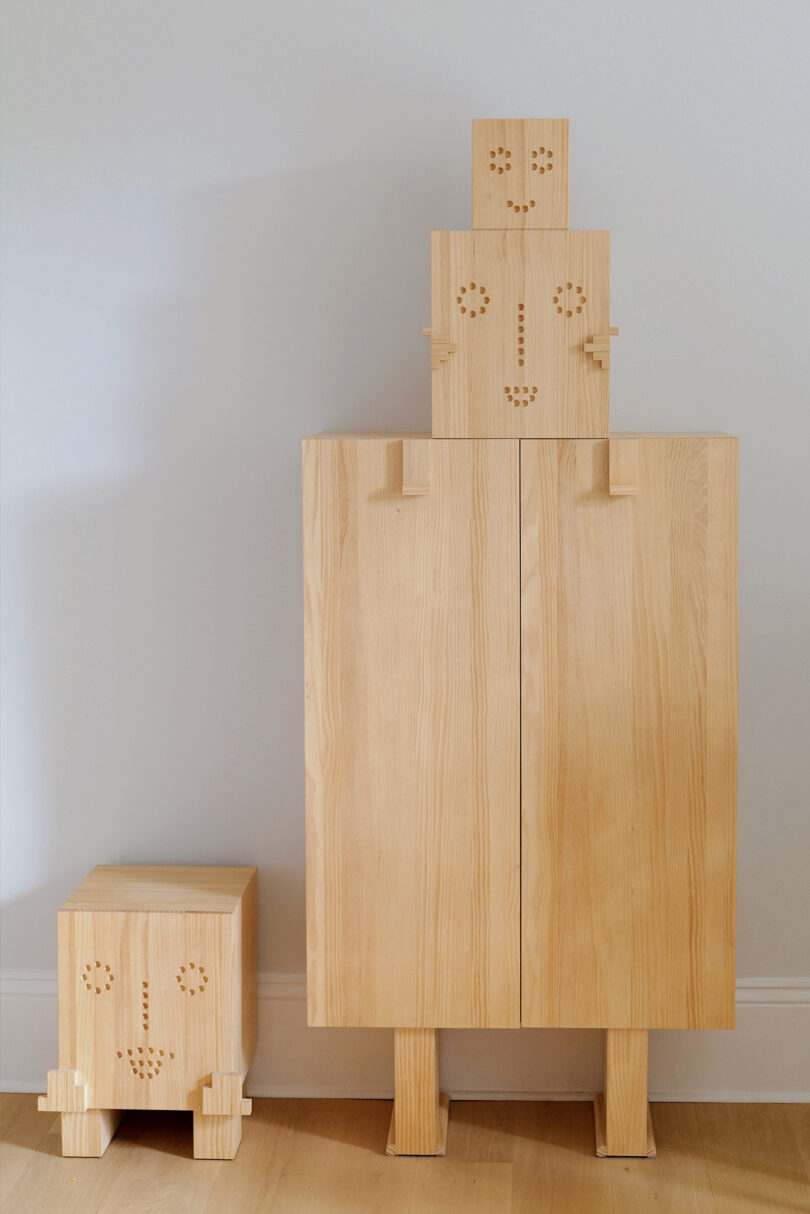 wooden cabinet and stool with faces on them