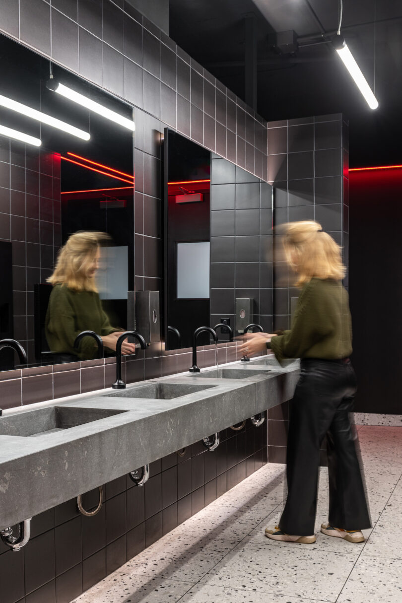 woman washing her hands in a restroom