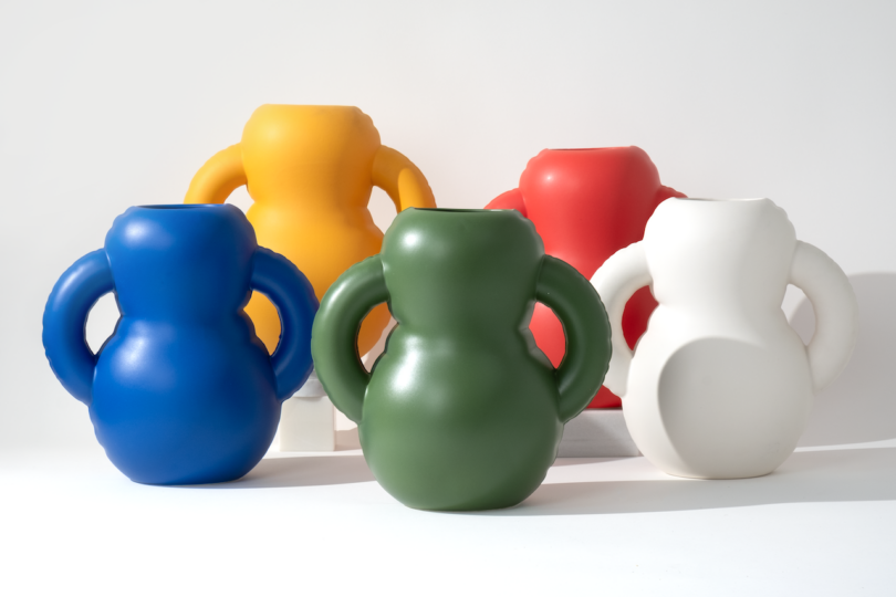 Five colorful vases arranged in a row on a white background.