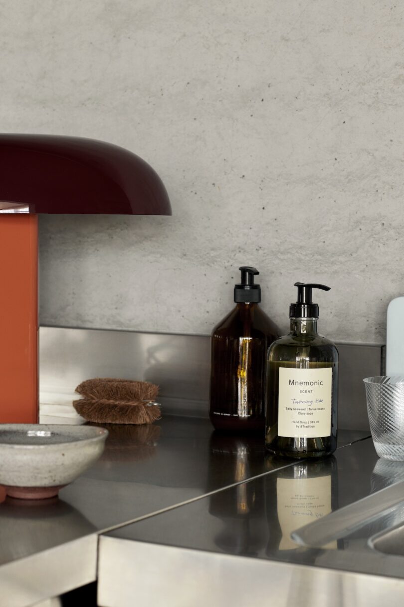 Modern bathroom countertop with assorted toiletries and decorative items 