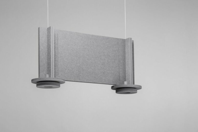 two grey felt pendant lights connected by a felt panel
