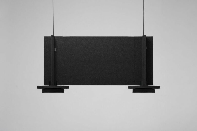 two black felt pendant lights connected by a felt panel