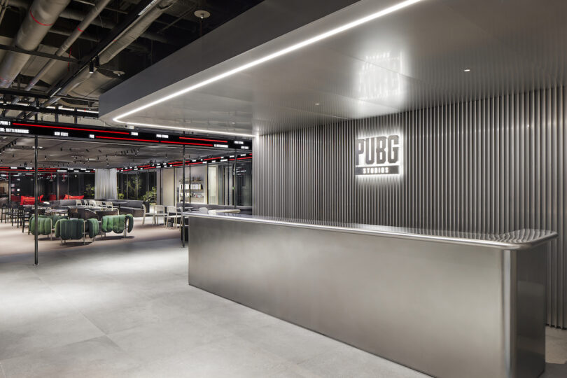 Modern office reception area with pubg studios logo on the wall.