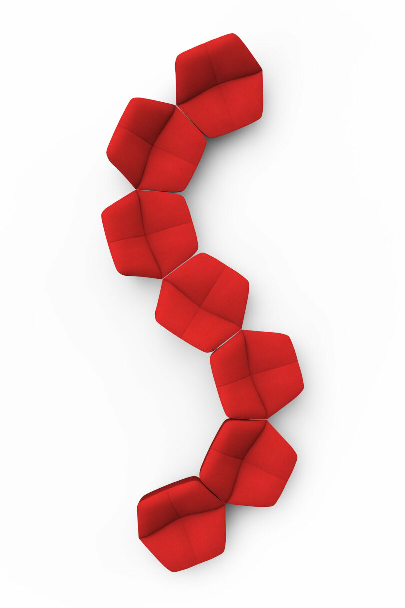 red chairs shaped like lips arranged in a squiggle