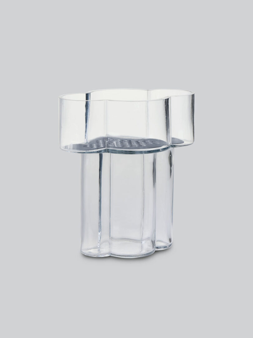 clear vase with metal insert on grey background