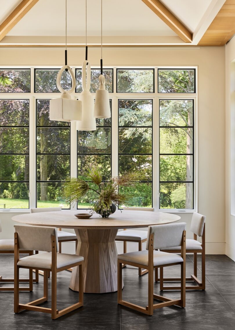Dining area with round dining table and large windows