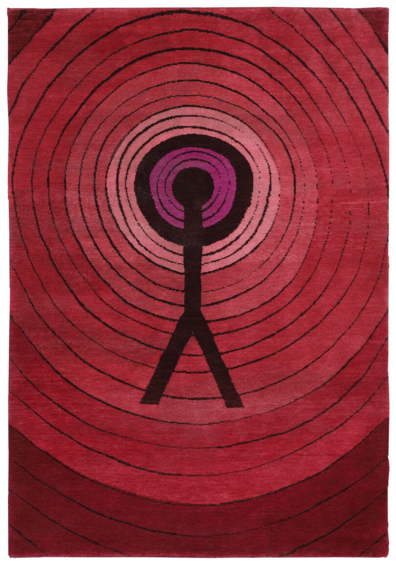 red rug with radiating lines and a black figure
