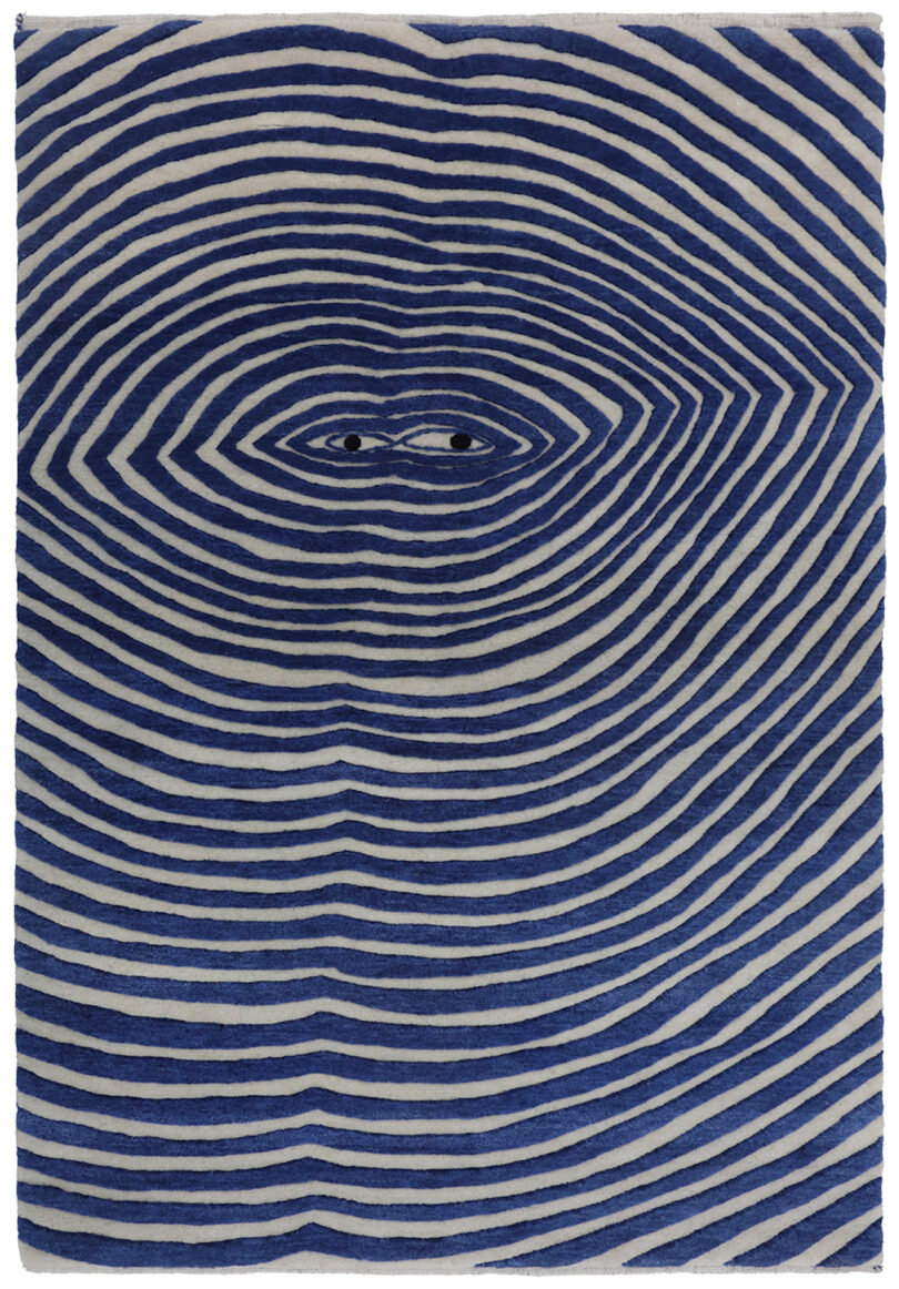 blue and white rug with radiating lines