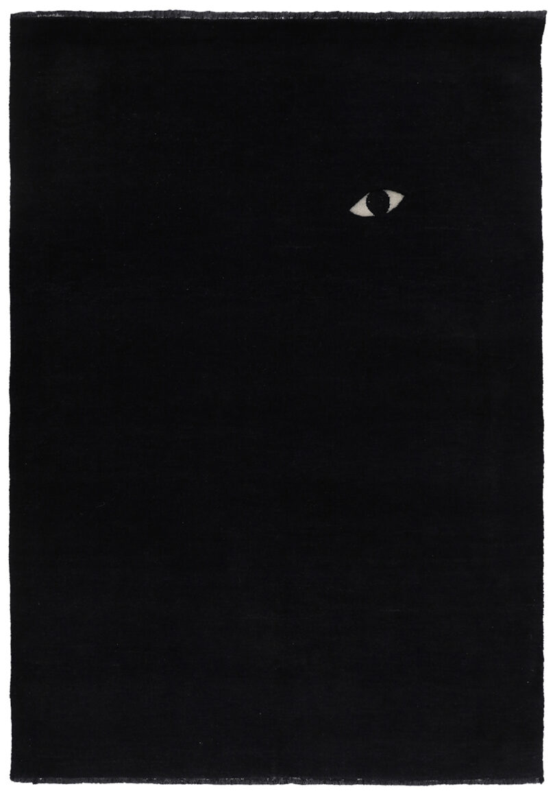 black rug with an eye