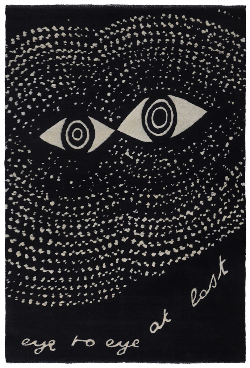 black and white rug with a pair of eyes with the words "eye to eye at last"