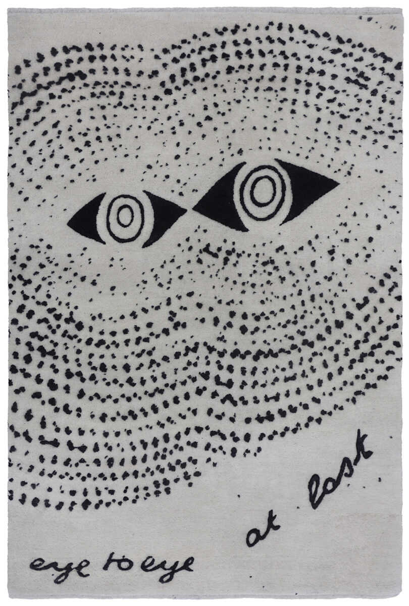 black and grey rug with a pair of eyes with the words "eye to eye at last"