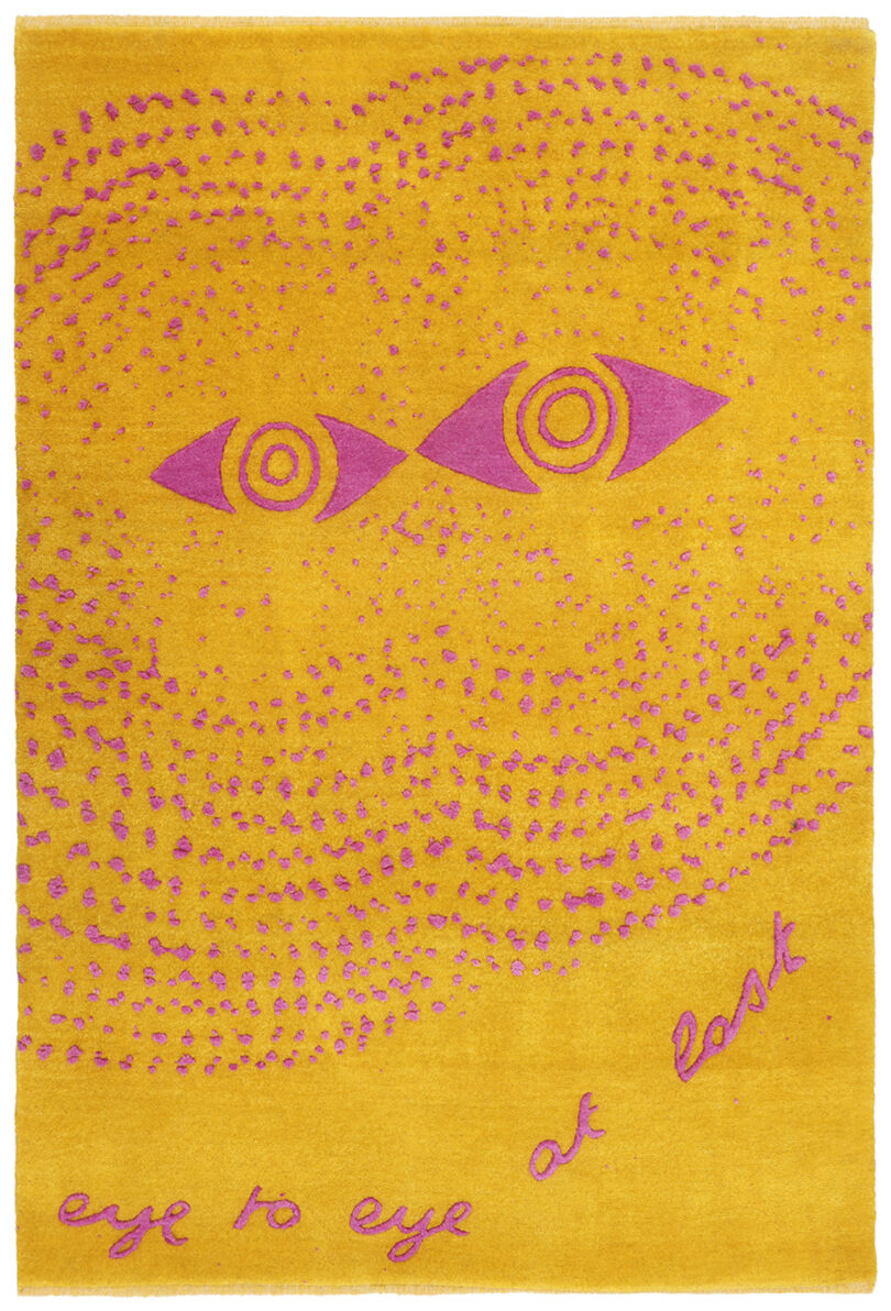 yellow and pink rug with a pair of eyes with the words "eye to eye at last"