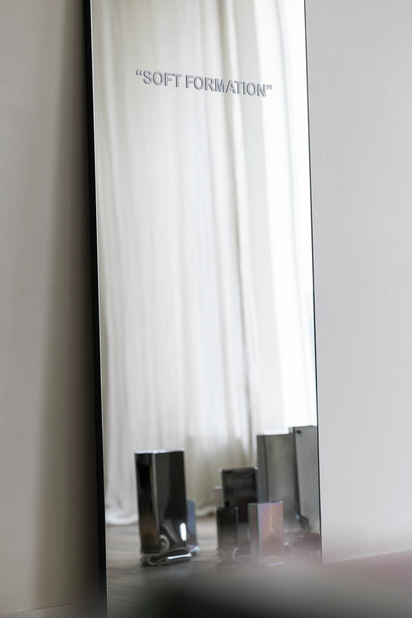 mirror with vinyl lettering that says soft formation