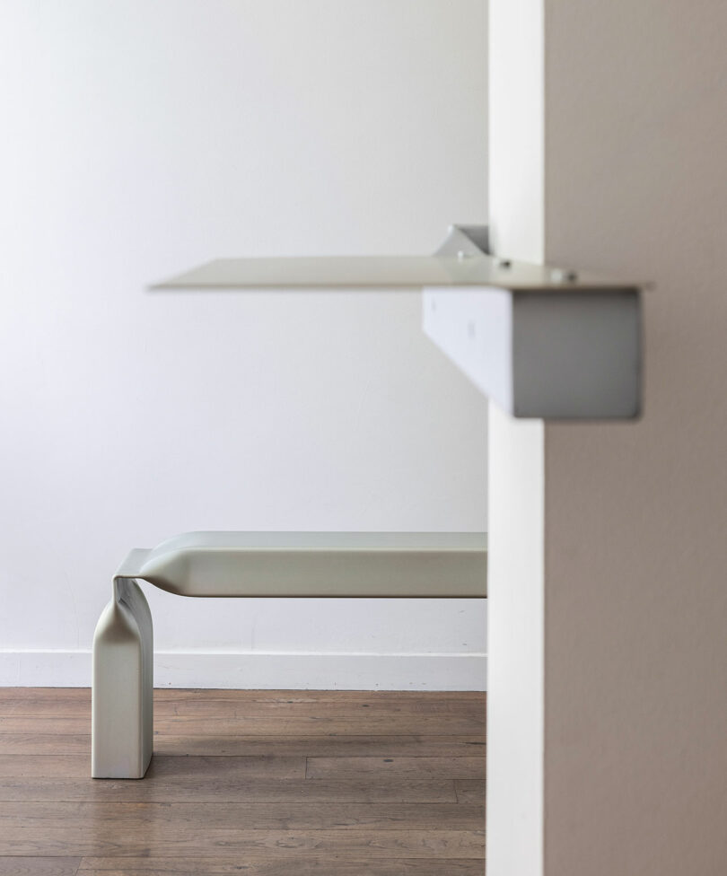 bent metal bench and wall mounted metal shelf