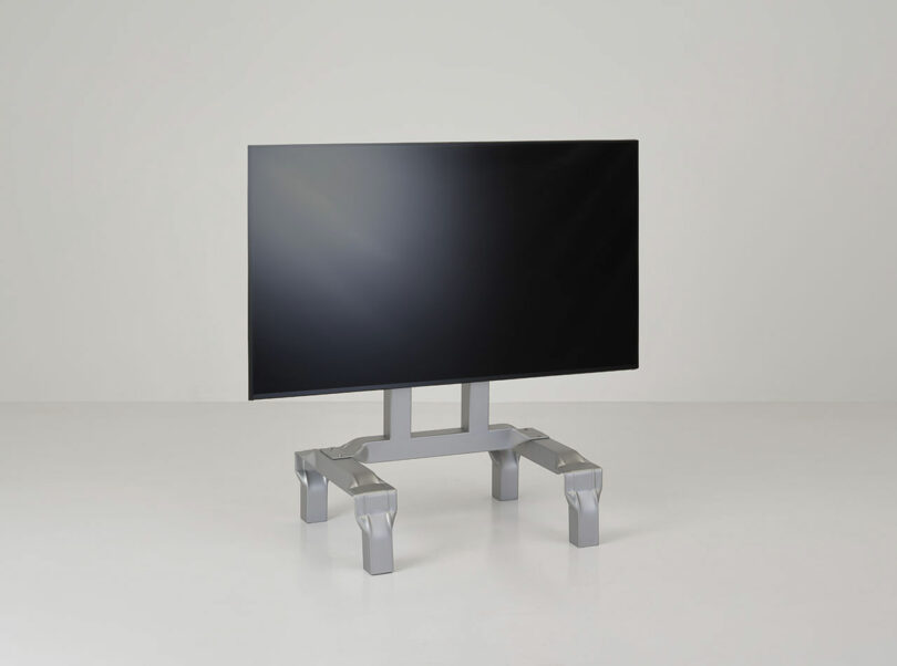 angled view of metal stand with TV attached
