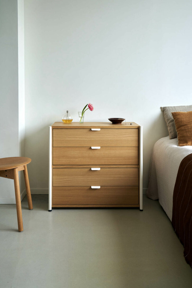 wooden dresser next to a bed