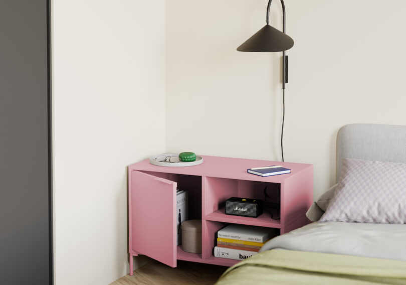 angled partial view of a modern bedroom with a pink bedside table