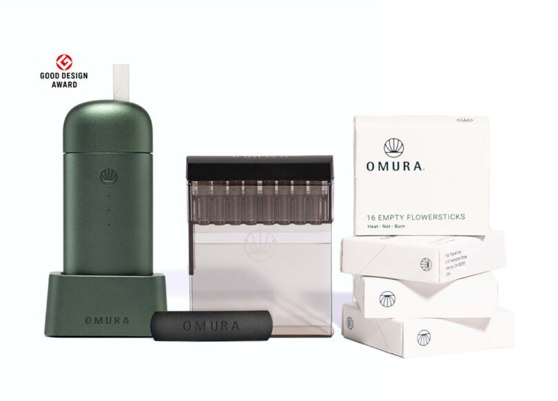 A green Omura vaporizer for cannabis with an additional pre-roll accessory and 4 boxes of empty flowersticks, all displaying the Omura logo.