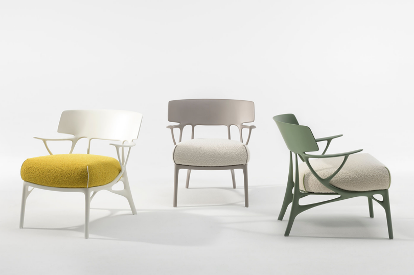 Three modern chairs with different designs and colors on a white background.