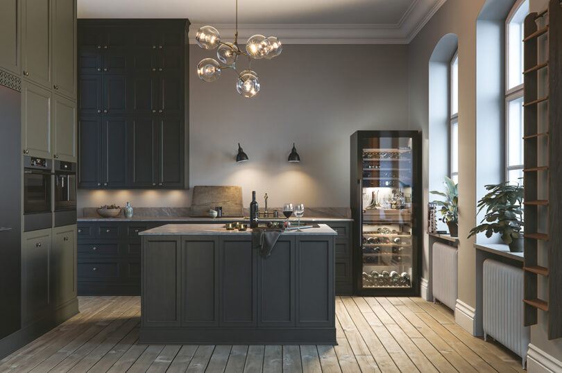Modern kitchen interior with dark cabinetry and wine fridge.