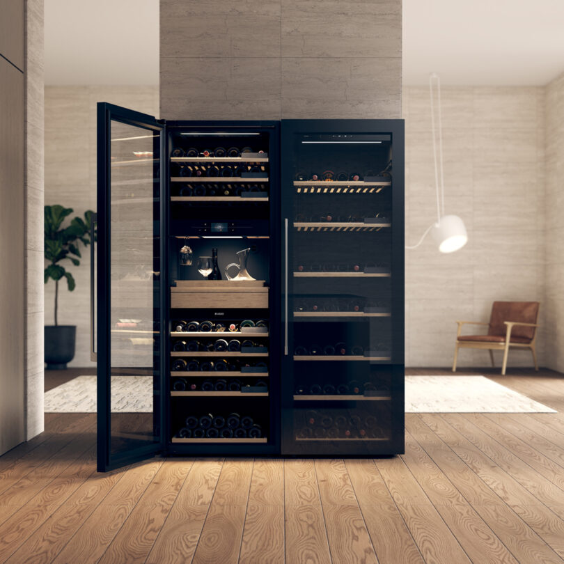 An open, dual-zone wine fridge filled with bottles in a modern home interior.