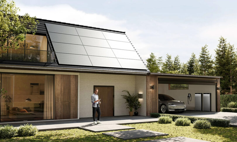 A modern house with solar panels and an Anker SOLIX X1 residential battery in garage and solar panels on the roof, featuring a man standing at the doorway, a car parked in the garage, and trees surrounding the property