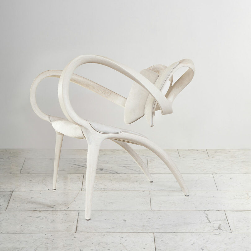 Surreal furniture concept: a chair with its elements twisted and curved in an unconventional manner, forming an arch.