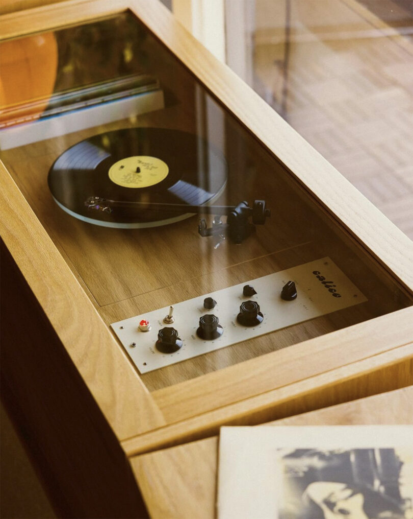 Calico HiFi Stereo Console with a vinyl record playing inside a wooden cabinet.