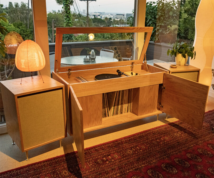 Mid-century modern style Calico HiFi Stereo Console with storage compartments, situated in a cozy living room at dusk.