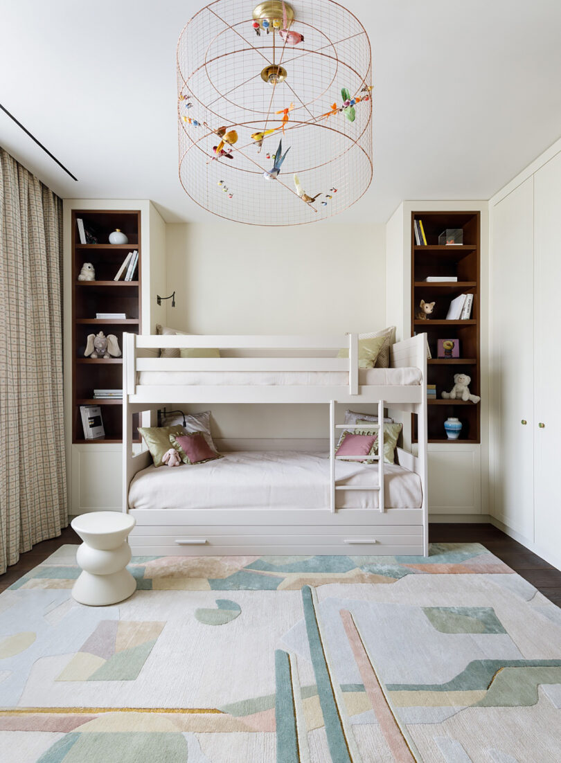 Abstract geometric pattern rug in pastel colors in a bedroom with bunkbeds.