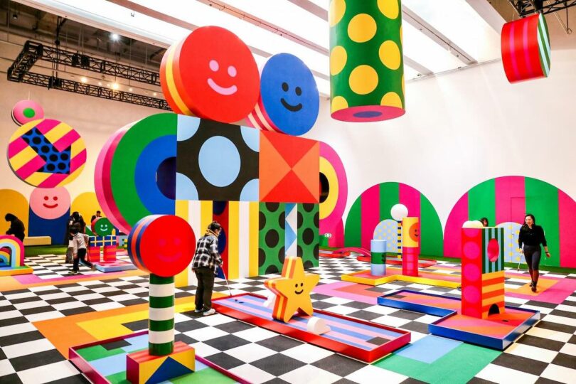 A mini golf installation that's part of an art exhibition featuring colorful sculptures throughout