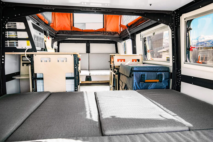 Interior of a Dark Sky Mantis adventure trailer with a bed and storage compartments set for up to 4 occupants, ready for an adventure.