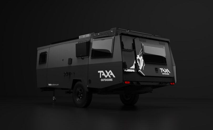 A black off-road Mantis adventure trailer with TXA branding parked against a dark background.
