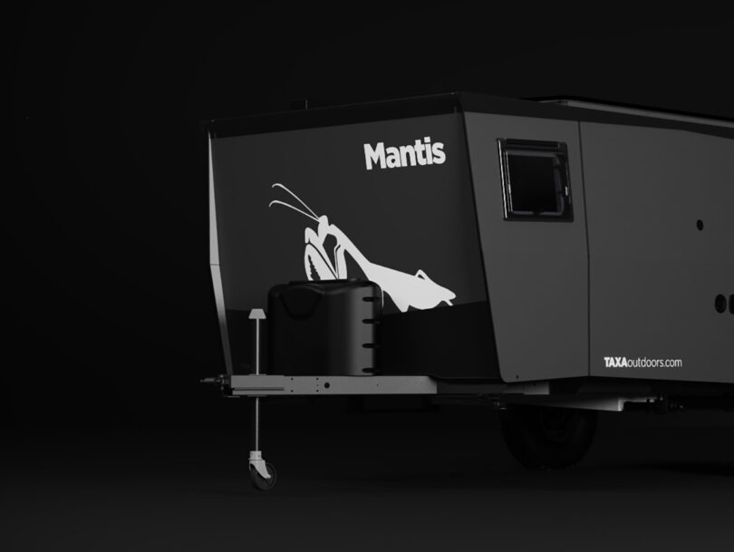 Black and gray Dark Sky Mantis adventure trailer with the word "Mantis" and a praying mantis graphic displayed on the front side near the trailer hitch.