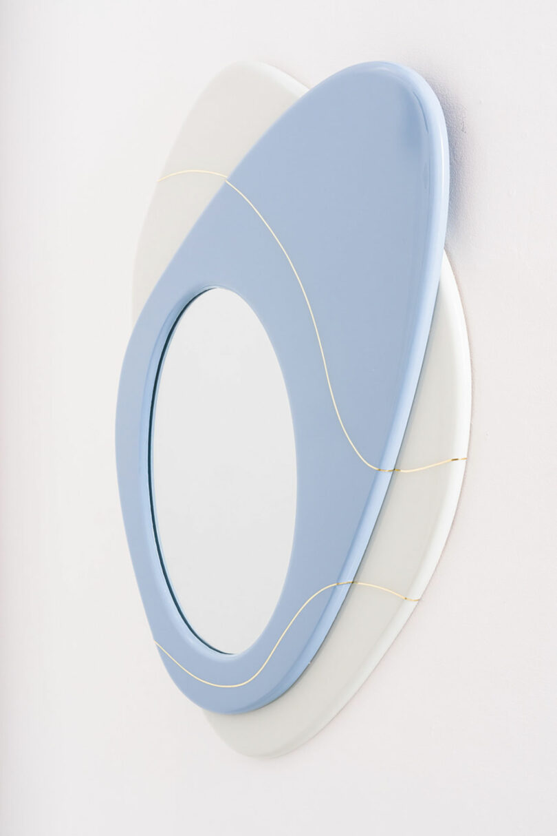 Abstract mirror by Djivan Schapira, composed of overlapping circular forms in shades of blue and cream, embellished with delicate gold lines.