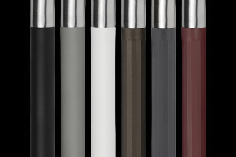 Close-up of various colored handles and levers arranged in a row, showcasing shades of black, gray, white, and red.
