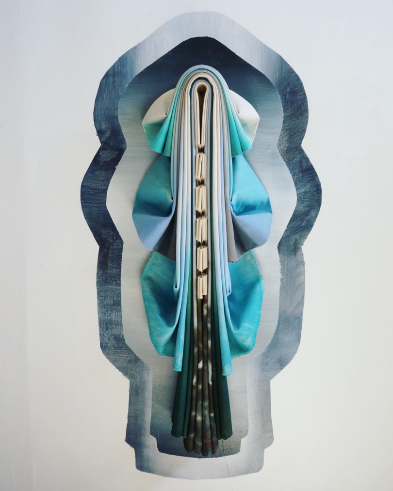 Mounted wall sculpture in blue and gray.